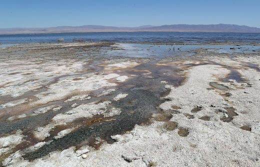 Stagnant water and mud pools just beneath the surface of the playa where the Salton Sea continues to shrink at the northwest end of Salton Sea, April 30, 2019.